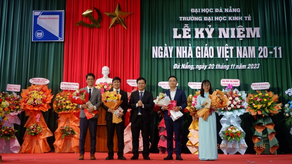 PGS.TS Lê Văn Huy, Hiệu trưởng trường Đại học Kinh tế Đà Nẵng tặng hoa chúc mừng các tân tiến sĩ (Ảnh: Đ.Minh)