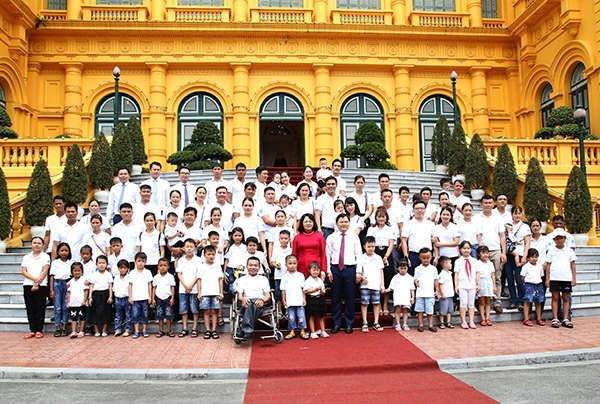 Ph&oacute; Chủ tịch nước Đặng Thị Ngọc Thịnh v&agrave; B&iacute; thư Thường trực Trung ương Đo&agrave;n, Chủ tịch Trung ương Hội Li&ecirc;n hiệp Thanh ni&ecirc;n Việt Nam Nguyễn Anh Tuấn chụp ảnh c&ugrave;ng c&aacute;c gia đ&igrave;nh trẻ ti&ecirc;u biểu